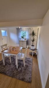 a dining room with a wooden table and chairs at Unterkunft Sanic in Kronberg im Taunus