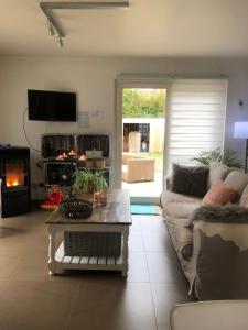 a living room with a couch and a table at A l'orée du bois "maison de vacances" in Spa
