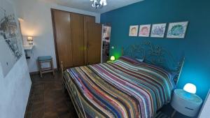 a bedroom with a bed with a colorful blanket at Casa Vacanza San Piero in San Piero in Campo
