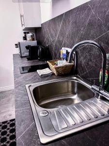 a kitchen sink with a faucet in a kitchen at Glenariff Forest Getaway in Glenariff