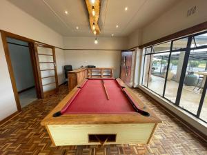 a pool table in the middle of a room at Heydays B&B in Noupoort