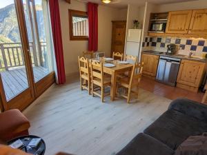 a kitchen and dining room with a table and chairs at Appartement Orcières Merlette, 3 pièces, 8 personnes - FR-1-262-170 in Orcières