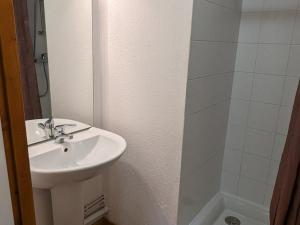 a white bathroom with a sink and a shower at Appartement Orcières Merlette, 3 pièces, 8 personnes - FR-1-262-170 in Orcières