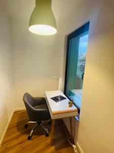 a desk and a chair in a room with a window at modern * gemütlich * Nespresso * Terrasse * Netflix in Duisburg