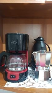 a blender sitting on a table next to a tea pot at Aqui é pé na areia in Santos