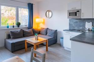 a living room with a couch and a table at Morgenrot in Dranske