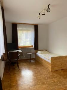 a bedroom with a bed and a desk and a table at Ruhige 4 Zimmer EG-Wohnung Z1 in Königsbronn