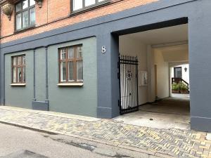 a blue building with a gate and a door at 2 Bedroom Apartment In Odense City Center in Odense