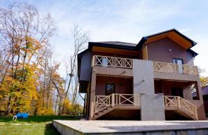 a large house with a balcony on the front of it at CHALET WOODS GUSAR in Qusar