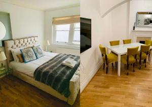 um quarto com uma cama, uma mesa e uma sala de jantar em 2 Bedroom flat in diplomatic enclave in Kensington em Londres