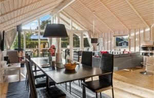 - une salle à manger et un salon avec une table et des chaises dans l'établissement 4 Bedroom Amazing Home In Bog By, à Bogø By