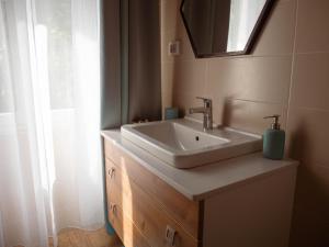 a bathroom with a sink and a mirror at Garden Rovinj in Rovinj +20 photos