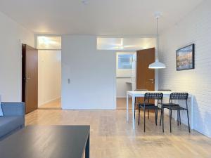 a dining room and living room with a table and chairs at One Bedroom Apartment In Valby, Langagervej 64, in Copenhagen