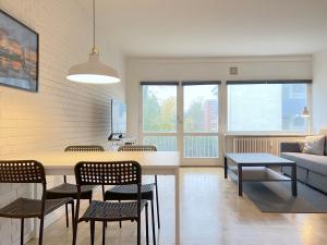 a living room with a table and chairs and a couch at One Bedroom Apartment In Valby, Langagervej 64, in Copenhagen