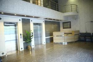 a lobby with two doors and a potted plant at Gulberg Suites in Lahore