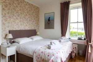 a bedroom with a bed and a window at Cawdor House B&B in Nairn +31 photos