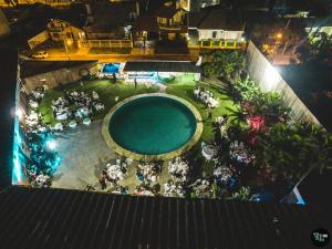 an overhead view of a swimming pool at night at Hotel Sambura in Imbé