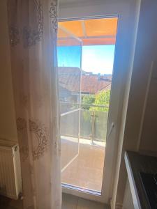 a sliding glass door with a view of a balcony at Luxuriant Arad Centru in Arad