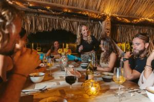 a group of people sitting around a table at Windhoek Resort Bonaire in Kralendijk