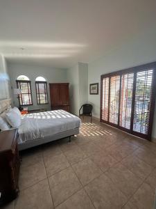 a bedroom with a bed and a large window at Tahitian Inn Boutique Hotel Tampa in Tampa