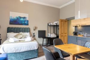 a bedroom with a bed and a table and chairs at MONO Suites NEW TOWN in Edinburgh
