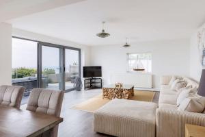 a living room with a couch and a table at Cove Lodge in Portland