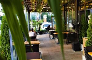a view of a restaurant with tables and plants at Complex Carol in Buzău