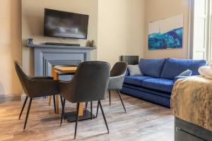 a living room with a couch and a table and chairs at MONO Suites NEW TOWN in Edinburgh