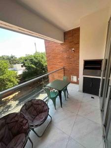 Il dispose d'une terrasse avec une table et des chaises. dans l'établissement Hermoso apartamento en Asuncion, à Asuncion