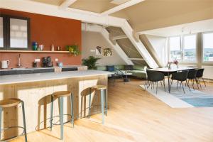 a kitchen and dining room with a table and chairs at POHA House Theaterplatz in Aachen