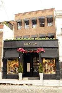 a store front of a brick building with a black facade at Casa Chic Palermo Soho in Buenos Aires