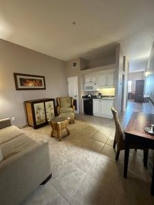 a living room with a couch and a table at Tahitian Inn Boutique Hotel Tampa in Tampa