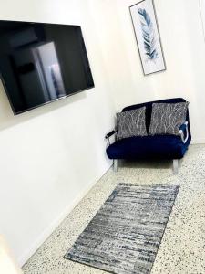 a living room with a blue couch and a rug at Lovely 1-Bedroom Apartment in Miami