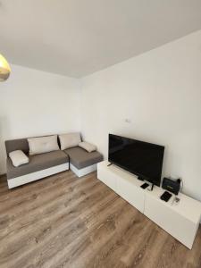 a living room with a couch and a flat screen tv at Modern Cozy Suite - Vracar in Vračar (historical)