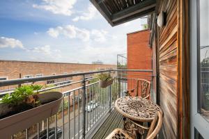 a balcony with a table and chairs on a building at King's Cross Cabin in London