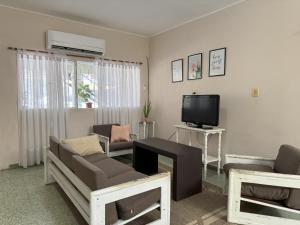 a living room with a couch and a tv at La Pilar in Formosa