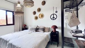 a bedroom with a bed with white sheets and pillows at Casa Boutique Luxury Yumbo in Playa del Ingles