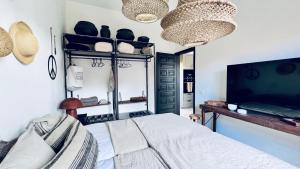 a bedroom with a bed and a flat screen tv at Casa Boutique Luxury Yumbo in Playa del Ingles