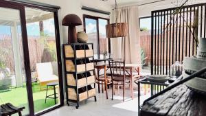 a living room with a table and chairs and a dining room at Casa Boutique Luxury Yumbo in Playa del Ingles