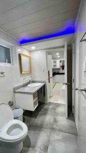 a bathroom with a white toilet and a sink at KANDI Palace, 2-Bedroom serviced Apartment in Angeles
