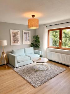 a living room with a couch and a table at JUPAS - Premium Apartments Trier in Trier +16 photos