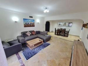 a living room with a couch and a table at Superbe appartement lumineux in Marrakesh