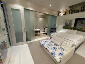 a bedroom with a bed and a dining room at Modern self-contained Ground and Basement studios in London