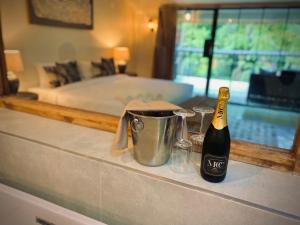 a bottle of champagne on a counter in a bedroom at Sakae Paradise Resort in Lusaka