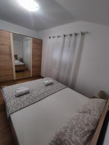 a bedroom with a bed with two towels on it at Apartments Marko Maros in Kotor