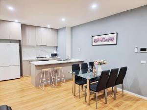 a kitchen and dining room with a table and chairs at Rosie Townhouse - Modern home in Sunshine in Albion