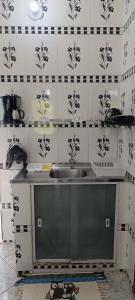 a kitchen with a sink and black and white tiles at Casa Goio Morro de São Paulo in Morro de São Paulo +35 photos