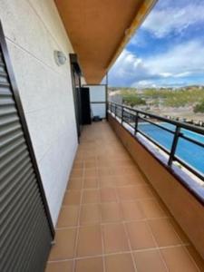 a balcony of a building with a view of the ocean at Apartamento céntrico Playa de Aro con piscina. in Platja  d'Aro