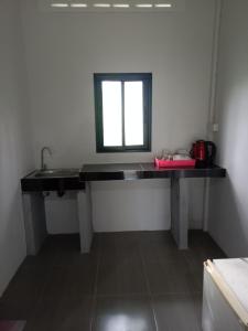 a bathroom with a sink and a mirror at Som PalmGarden in Ko Lanta