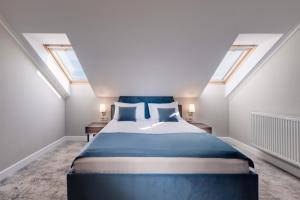 a bed in a room with skylights at Hotel Meridian in Cluj-Napoca